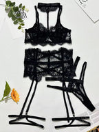 Black lace lingerie set on a light background with floral decorations
