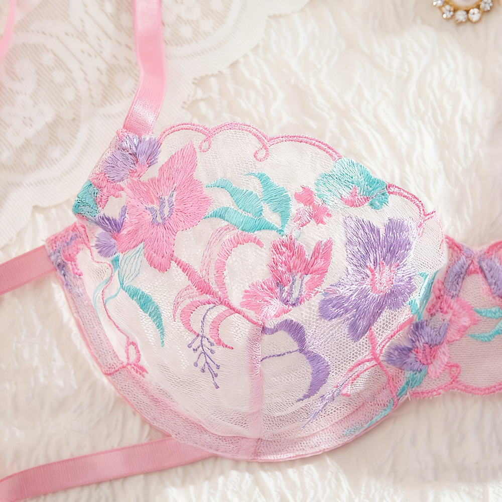 Floral embroidered bralette with pink straps on a soft white background