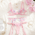 Pink lingerie set with floral details on a soft white background
