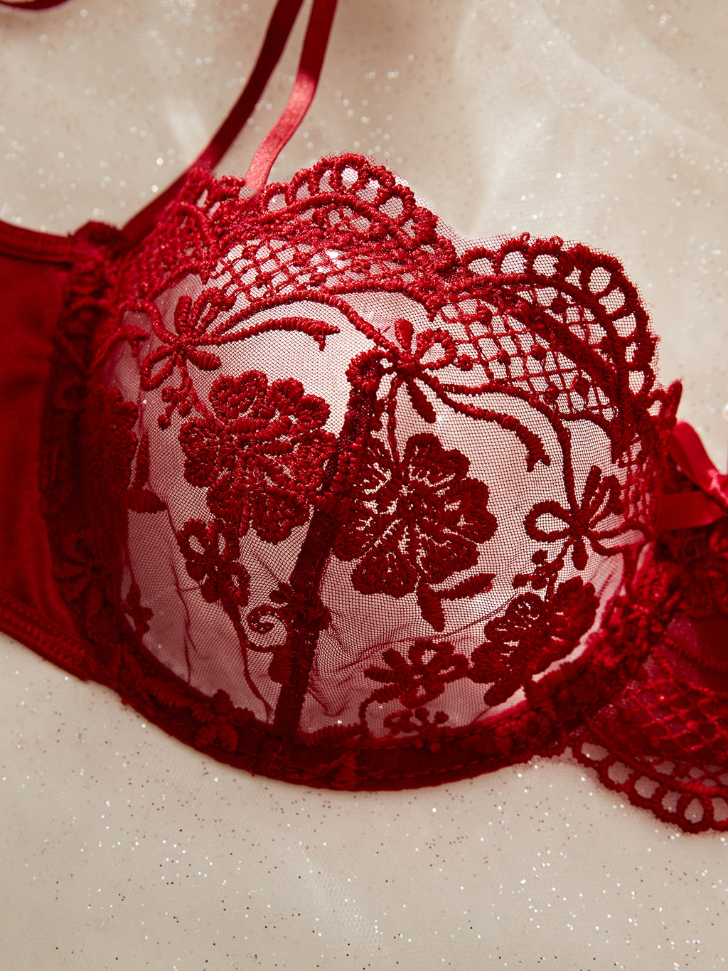 Red lace bra on a beige background