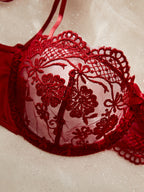 Red lace bra on a beige background
