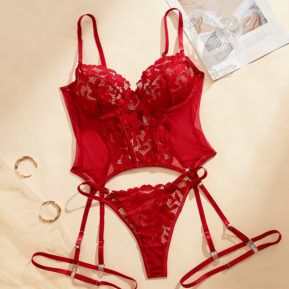 Red lace lingerie set on a beige background with a magazine.