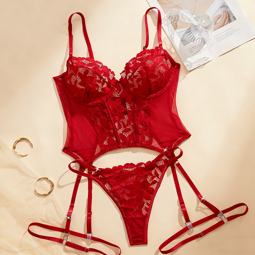 Red lace lingerie set on a beige background with a magazine.