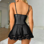 Black lace babydoll dress worn by a person in a bedroom setting